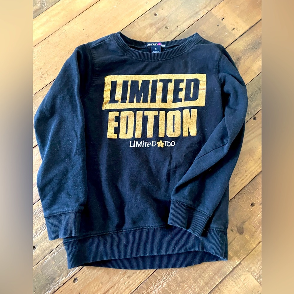 Girls size 6 long sleeve black limited addition sweater